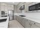 Well-appointed kitchen featuring stainless steel appliances, custom cabinetry, and a sleek gas cooktop at 37785 W Santa Maria St, Maricopa, AZ 85138