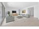 Bright living room with modern decor, neutral tones, and a sliding glass door to the outdoor space at 37785 W Santa Maria St, Maricopa, AZ 85138