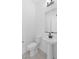 Contemporary powder room showcasing a pedestal sink, modern faucet, and sleek, minimalist design elements at 37785 W Santa Maria St, Maricopa, AZ 85138