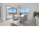 Cozy dining area with a modern chandelier, a round table, and a view to the backyard at 37805 W Santa Maria St, Maricopa, AZ 85138