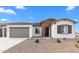 Charming single-story home with a stone accent wall, desert landscaping, and a two-car garage at 37805 W Santa Maria St, Maricopa, AZ 85138