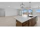 Open kitchen with a large island, a modern faucet, and a view into the living space at 37805 W Santa Maria St, Maricopa, AZ 85138