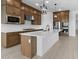 Spacious kitchen with stainless steel appliances, a large island, and custom wood cabinetry at 37805 W Santa Maria St, Maricopa, AZ 85138
