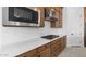 Detailed view of the kitchen's stainless steel appliances, white subway tile backsplash, and wood cabinetry at 37805 W Santa Maria St, Maricopa, AZ 85138