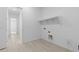 Bright laundry room with ample space for laundry machines and storage at 37805 W Santa Maria St, Maricopa, AZ 85138