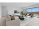 Bright living room with neutral decor, tile floors, and sliding glass doors to backyard at 37805 W Santa Maria St, Maricopa, AZ 85138