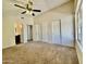 Spacious carpeted bedroom with neutral walls, bright windows, and ample closet space at 3877 W Butler St, Chandler, AZ 85226