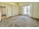 Relaxing bedroom with plush carpeting, a window with curtains, and neutral paint colors at 3877 W Butler St, Chandler, AZ 85226