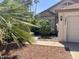 Well-maintained home exterior with desert landscaping, palm trees, and a two-car garage at 3877 W Butler St, Chandler, AZ 85226