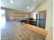 Bright kitchen featuring a stainless steel refrigerator, open shelving, and ample countertop space at 3877 W Butler St, Chandler, AZ 85226