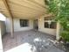 Covered outdoor patio area featuring neutral paint, tile flooring, and two large windows at 3877 W Butler St, Chandler, AZ 85226