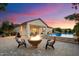 Outdoor living space features a fire pit, pool, and covered patio with seating at 3912 E Ellis St, Mesa, AZ 85205