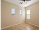Neutral bedroom with tile flooring, ceiling fan, and three windows with blinds at 3912 E Ellis St, Mesa, AZ 85205