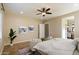 Spacious bedroom with a ceiling fan, neutral walls, and a view of the ensuite bathroom at 3912 E Ellis St, Mesa, AZ 85205