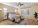 Serene bedroom with plantation shutters, a ceiling fan, and a cozy sitting area at 3912 E Ellis St, Mesa, AZ 85205