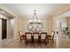 Elegant dining room featuring a decorative chandelier, stylish mirrors, and seating for eight at 3912 E Ellis St, Mesa, AZ 85205