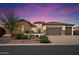 Stunning single-story home with lush landscaping, a stone facade, and a three-car garage at 3912 E Ellis St, Mesa, AZ 85205