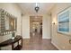 Bright foyer featuring neutral walls, tile floors, a console table, and a decorative mirror at 3912 E Ellis St, Mesa, AZ 85205