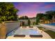 Backyard area with a hot tub, green landscaping, and privacy fence at 3912 E Ellis St, Mesa, AZ 85205