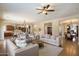 Open-concept living room with a ceiling fan, cozy seating, and views into dining and kitchen areas at 3912 E Ellis St, Mesa, AZ 85205