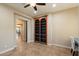 Bright home office with custom built-in shelving and a doorway to the dining room at 3912 E Ellis St, Mesa, AZ 85205