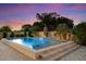 Beautiful pool with waterfall feature and lush landscaping in the backyard at 3912 E Ellis St, Mesa, AZ 85205