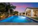 Gorgeous pool with water feature surrounded by mature landscaping at 3912 E Ellis St, Mesa, AZ 85205