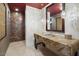 Contemporary bathroom with stone countertops, tile accents, and unique lighting at 39254 N 104Th Pl, Scottsdale, AZ 85262