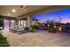Serene covered patio with stylish seating, lush landscaping, and a tranquil desert backdrop at 39254 N 104Th Pl, Scottsdale, AZ 85262