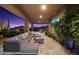 Inviting covered patio with comfortable seating, a cozy fire pit, and scenic desert views at 39254 N 104Th Pl, Scottsdale, AZ 85262