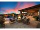Inviting outdoor living space with a fire pit, pool, and covered patio at 39254 N 104Th Pl, Scottsdale, AZ 85262