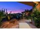 Outdoor living space with a fire pit, pool, desert landscaping, and cozy lounge chairs at 39254 N 104Th Pl, Scottsdale, AZ 85262