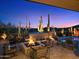 Relaxing outdoor area featuring a fire pit, pool, and comfortable seating with desert views at 39254 N 104Th Pl, Scottsdale, AZ 85262