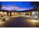 A warm and inviting home exterior with a paver driveway, 3-car garage, and desert landscaping at 39254 N 104Th Pl, Scottsdale, AZ 85262