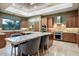 The gourmet kitchen boasts custom cabinets, a large island, stainless appliances, granite countertops and breakfast bar at 39254 N 104Th Pl, Scottsdale, AZ 85262