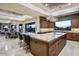 The gourmet kitchen boasts custom cabinets, a large island, stainless appliances, granite countertops and a breakfast bar at 39254 N 104Th Pl, Scottsdale, AZ 85262