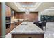The gourmet kitchen features custom cabinets, a large island, stainless appliances, granite countertops and breakfast bar at 39254 N 104Th Pl, Scottsdale, AZ 85262