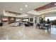 Spacious living area with stone fireplace, travertine floors, comfortable seating, and backyard views at 39254 N 104Th Pl, Scottsdale, AZ 85262