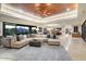 Open-concept living area with travertine floors, comfortable seating, and seamless backyard views at 39254 N 104Th Pl, Scottsdale, AZ 85262