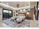 The main bedroom features patio access, a ceiling fan, a sitting area and designer touches at 39254 N 104Th Pl, Scottsdale, AZ 85262