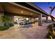 Picturesque outdoor living space with a covered patio, dining set, and desert-inspired art at 39254 N 104Th Pl, Scottsdale, AZ 85262