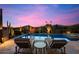 Inviting pool and spa area with desert landscaping and lounge chairs against a vibrant sunset at 39254 N 104Th Pl, Scottsdale, AZ 85262