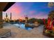 Beautiful pool and spa with desert landscaping under a colorful evening sky at 39254 N 104Th Pl, Scottsdale, AZ 85262
