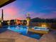 Stunning pool and spa with desert landscaping at dusk, creating a serene backyard oasis at 39254 N 104Th Pl, Scottsdale, AZ 85262