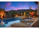 Inviting pool and spa area with desert landscaping and lounge chairs against a vibrant sunset at 39254 N 104Th Pl, Scottsdale, AZ 85262