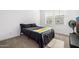 Simple bedroom featuring a black bed set against neutral carpeting with natural light from the window at 4077 S Sabrina Dr # 14, Chandler, AZ 85248
