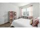 Carpeted bedroom with lots of natural light and a doll house that remains with the property at 4077 S Sabrina Dr # 14, Chandler, AZ 85248