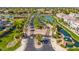 Aerial view of a gated entrance surrounded by lush landscaping, ponds, and well-maintained lawns at 4077 S Sabrina Dr # 14, Chandler, AZ 85248