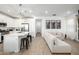 Spacious open-concept living space with modern kitchen, seating, and wood-look tile flooring at 4077 S Sabrina Dr # 14, Chandler, AZ 85248