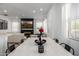 Open-concept living room with fireplace, TV, modern furnishings and bright, natural light at 4077 S Sabrina Dr # 14, Chandler, AZ 85248